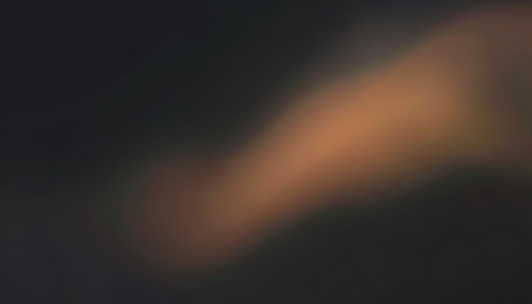 Deep charcoal panel with a faint golden highlight suggesting soft lighting.